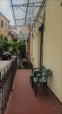 a row of green benches sitting next to a building at 1 bedroom apartment in old town with free parking in Vilnius