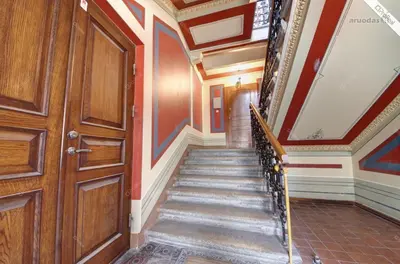 a hallway with a staircase and a wooden door at 1 bedroom apartment in old town with free parking in Vilnius