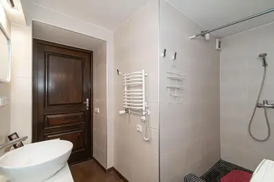 a bathroom with a toilet and a glass shower at 1 bedroom apartment in old town with free parking in Vilnius