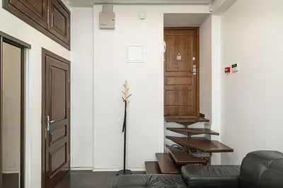 a living room with a couch and a stairway at 1 bedroom apartment in old town with free parking in Vilnius