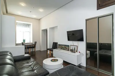 a living room with a couch and a flat screen tv at 1 bedroom apartment in old town with free parking in Vilnius