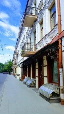 a building on a street next to at 1 bedroom apartment in old town with free parking in Vilnius