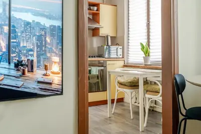 a kitchen with a table and a view of a city at Cosy 2 Bed Flat in Naujamiestis in Vilnius