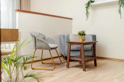 two chairs and a table in a room at Cosy 2 Bed Flat in Naujamiestis in Vilnius