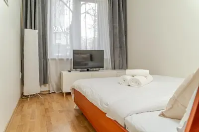 a bedroom with a bed and a tv on a table at Cosy 2 Bed Flat in Naujamiestis in Vilnius