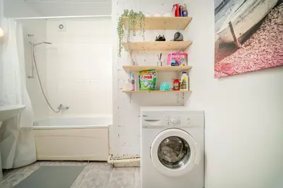 a laundry room with a washing machine in a bathroom at Cosy 2 Bed Flat in Naujamiestis in Vilnius