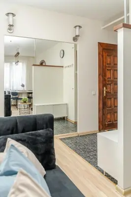 a living room with a couch and a projection screen at Cosy 2 Bed Flat in Naujamiestis in Vilnius