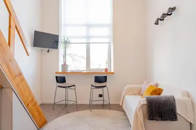 a living room with a couch and a table at Loftas Dumu fabrikas in Vilnius