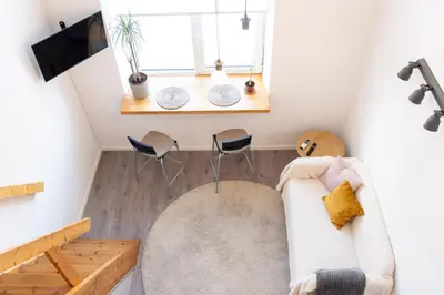 a living room with a couch and a table at Loftas Dumu fabrikas in Vilnius