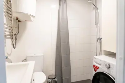 a bathroom with a toilet and a shower at Loftas Dumu fabrikas in Vilnius