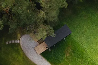 an overhead view of a park bench in a field at Blackview cabin in Kulautuva