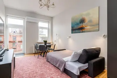a bedroom with a bed and a table and chairs at Charming Apartment in Kaunas Old Town in Kaunas