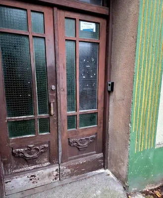 a wooden door with windows on the side of a building at Cozy Fryko Era Home - 1929, 2 double beds in Kaunas