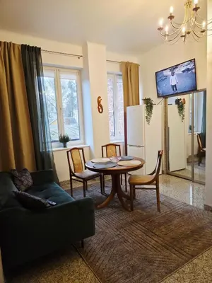 a living room with a table and chairs at Cozy Fryko Era Home - 1929, 2 double beds in Kaunas