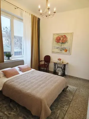 a bedroom with a large bed and a window at Cozy Fryko Era Home - 1929, 2 double beds in Kaunas