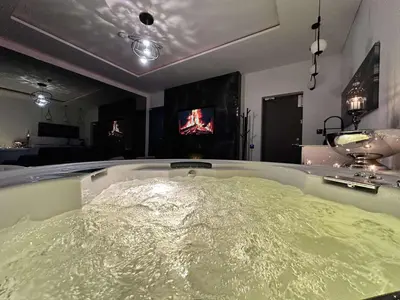 a bath tub filled with water in a room at Host 5 apartment in Kaunas