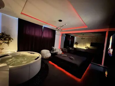 a room with a bathtub with red lights in it at Host 5 apartment in Kaunas