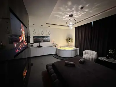 a large bathroom with a tub and a sink at Host 5 apartment in Kaunas