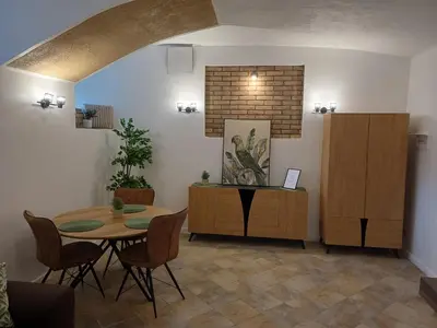 a dining room with a table and chairs in a room at Flowers appartments in Vilnius