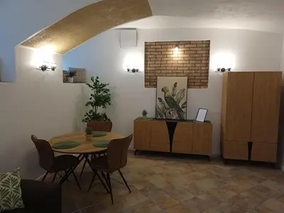 a dining room with a table and chairs in a room at Flowers appartments in Vilnius
