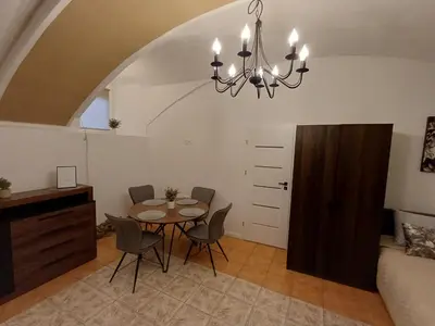 a dining room with a table and chairs in a room at Flowers appartments in Vilnius