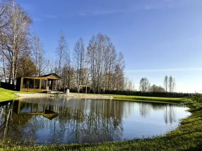 a small pond with a building next to it at Pas Milėją