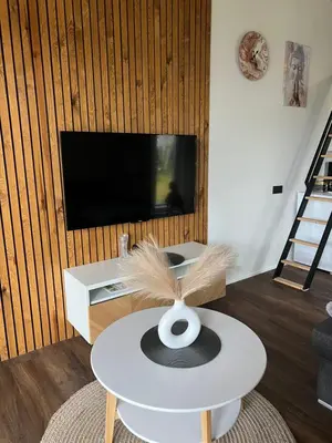 a hat sitting on a table in a living room at Pas Milėją