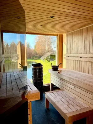 a wooden bench in a room with a large window at Pas Milėją