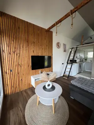 a living room with a table and a couch at Pas Milėją