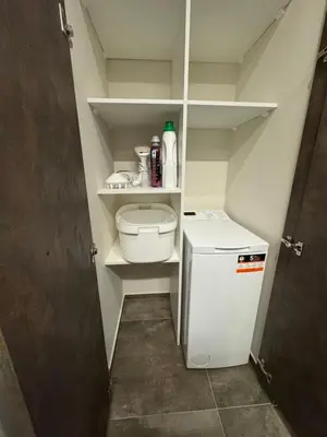 a small white refrigerator in a small kitchen at EGo Apartment in Vilnius