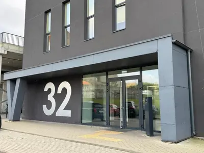 a building with a sign on the side of it at EGo Apartment in Vilnius
