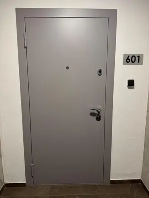 a door in a room with a clock on it at EGo Apartment in Vilnius