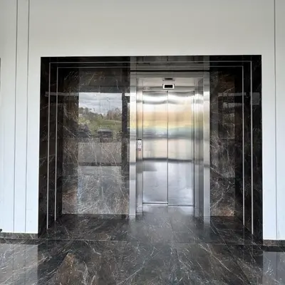 a hallway with a metal door in a building at EGo Apartment in Vilnius