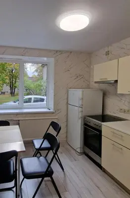 a kitchen with two chairs and a table and a window at Pas Dianą 1 aukštas in Jurbarkas