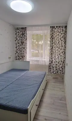 a bedroom with a bed with a blue mattress at Pas Dianą 1 aukštas in Jurbarkas