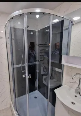 a man taking a picture of a shower in a bathroom at Pas Dianą 1 aukštas in Jurbarkas