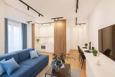 a living room with a blue couch and a table at Self Check-in Home in Vilnius center in Vilnius
