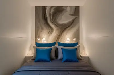 a bedroom with a bed with blue pillows at Self Check-in Home in Vilnius center in Vilnius