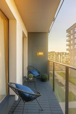 a balcony with chairs and a view of a city at Self Check-in Home in Vilnius center in Vilnius