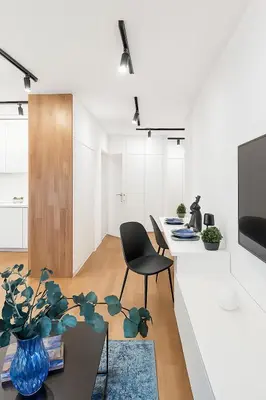 a kitchen and living room with a table and a chair at Self Check-in Home in Vilnius center in Vilnius