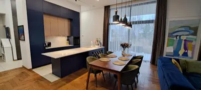 a kitchen and living room with a table and a couch at White house in Vilnius in Vilnius