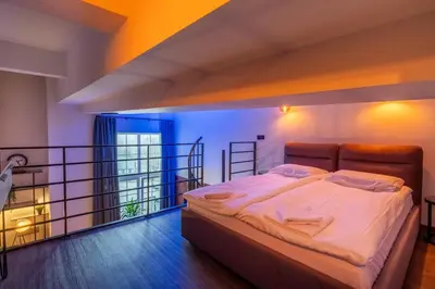 a bedroom with a bed on a balcony at SoHo Gallery Loft 437 in Kaunas