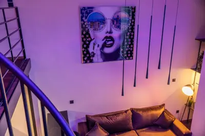 a room with a couch and a picture of a woman at SoHo Gallery Loft 437 in Kaunas