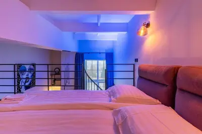 a bedroom with a bed and a couch at SoHo Gallery Loft 437 in Kaunas