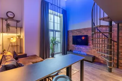 a living room with a couch and a fireplace at SoHo Gallery Loft 437 in Kaunas