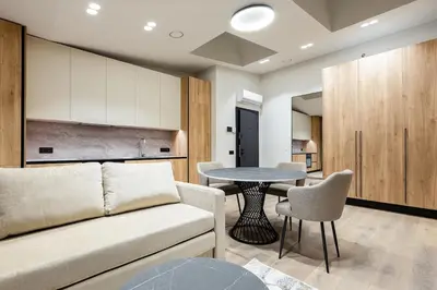 a living room with a couch and a table at Laisves alejos Apartments in Kaunas
