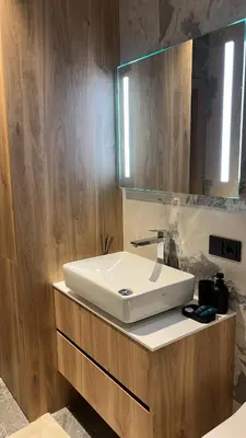 a bathroom with a white sink and a mirror at Laisves alejos Apartments in Kaunas