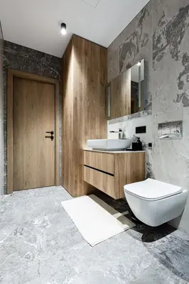 a bathroom with a white toilet and a sink at Laisves alejos Apartments in Kaunas