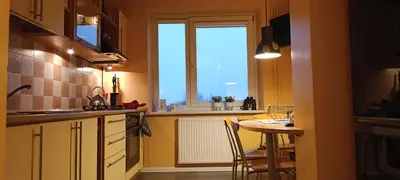 a small kitchen with a table and a window at Ruola in Kaunas
