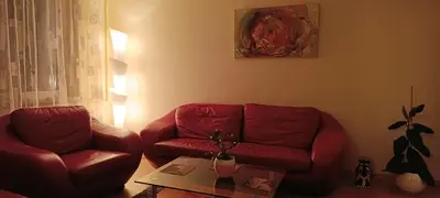 a living room with a red couch and a table at Ruola in Kaunas